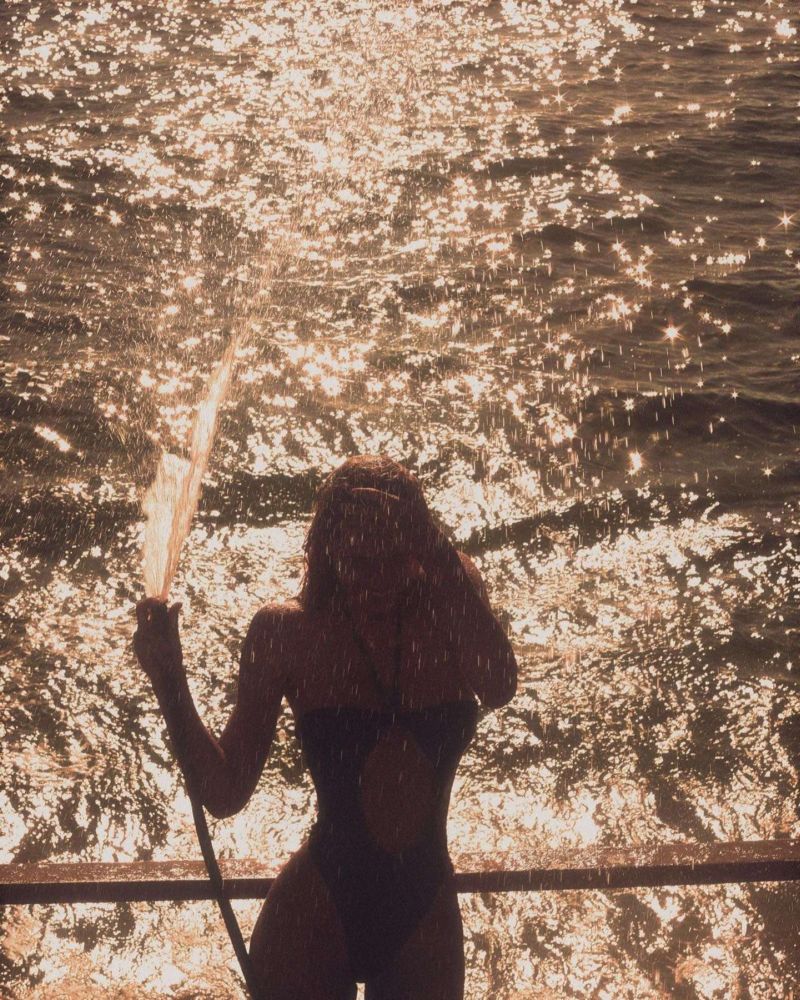 Alexis Ren In In A Black Swimsuit Photoshoot