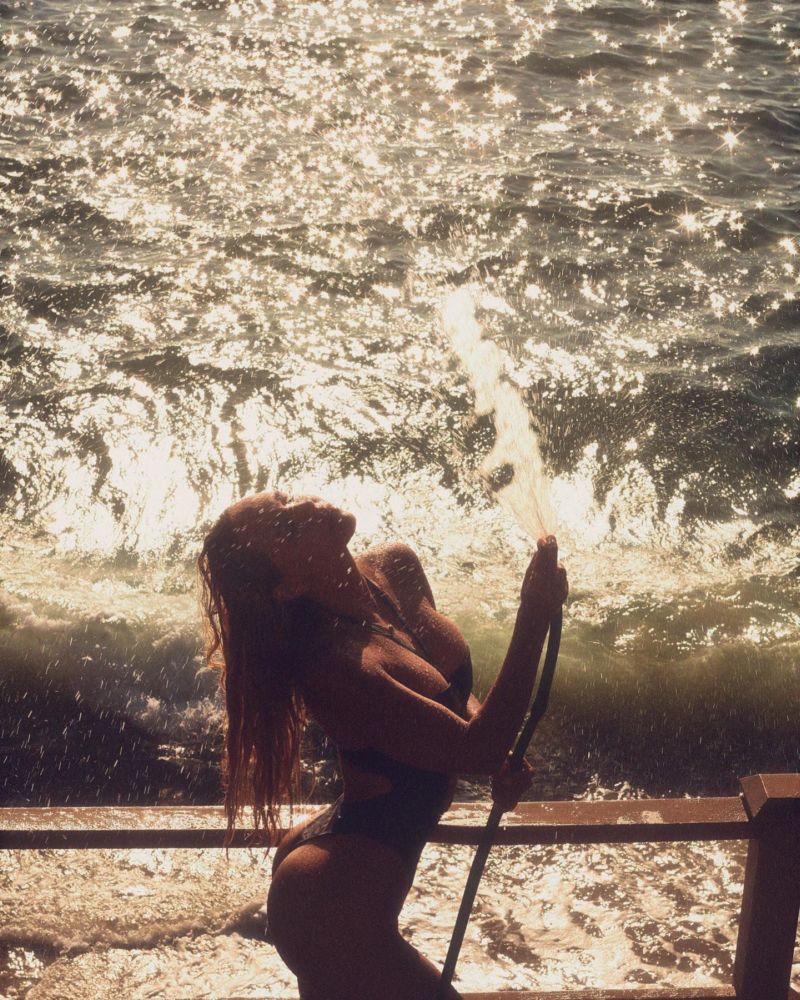 Alexis Ren In In A Black Swimsuit Photoshoot