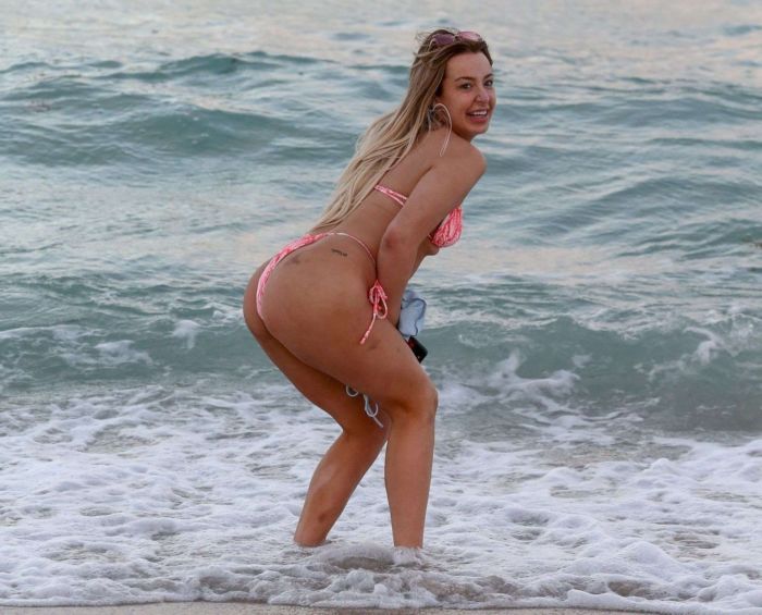 Tana Mongeau Hits The Beach In A Pink Bikini