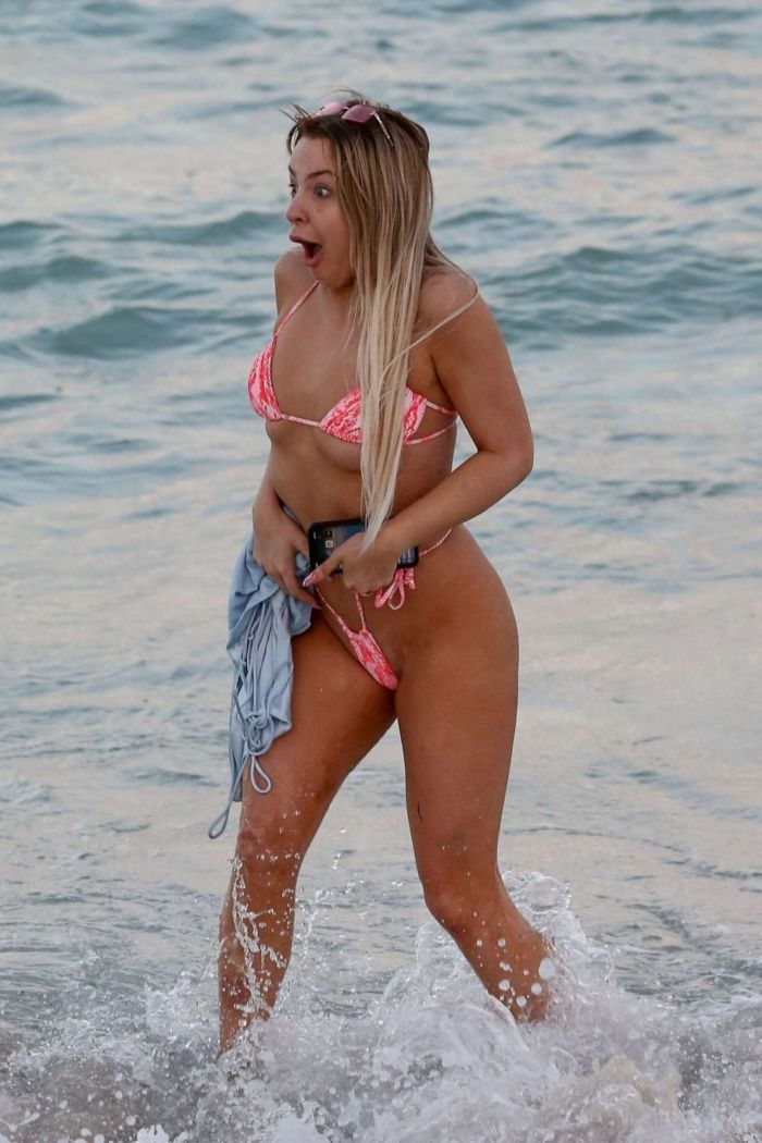 Tana Mongeau Hits The Beach In A Pink Bikini